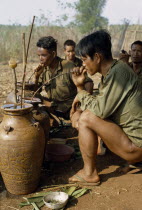 Vietnam War. Montagnard men drinking rice wineAsian Southeast Asia Viet Nam Vietnamese Male Man Guy Vino Vin Alcohol Grape Winery Drink