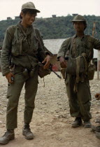 Meo soldiers carrying guns and grenadesAsian Lao Southeast Asia