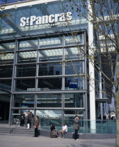 St Pancras International exterior.  New security sealed terminal for Eurostar trains to continental Europe with passengers waiting on steps in the sunshine outside European Great Britain Londres Nort...