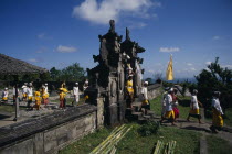 Procession of mourners leaving cremation ceremony in temple grounds. Besakih temple is situated on Mount Agung and known as the  Mother Temple of Bali. funeralfunerarydeathburialcustomtradition...