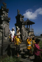 Procession of mourners leaving cremation ceremony in temple grounds.  Besakih temple is situated on Mount Agung and known as the  Mother Temple of Bali. funeralfunerarydeathburialcustomtradition...