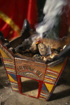 Frankincense burning in tomb of the prophet Job. Near Salalah.Ayoubincensearomaticperfumegum resin Middle East Omani Religion Religious