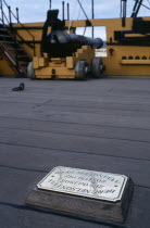 HMS Victory.  Detail of deck with cannon and brass plaque marking the spot where Admiral Nelson fell 21 October 1805.European Great Britain History Northern Europe UK United Kingdom