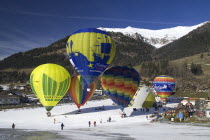 Hot Air Balloon taking off with others in preparation.European Schweiz Suisse Svizzera Swiss Western Europe Winter Snow Festivals International Balloon Festival Guangzhou Scenic