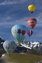 Hot Air Balloons in flight with mountain backdrop and typical house.European Schweiz Suisse Svizzera Swiss Western Europe  Hot Air Balloons Leisure Transport Guangzhou Scenic