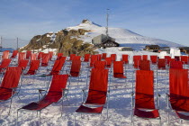 Deckchairs on Mannlichen Mountain with cable car station at rearEuropean Schweiz Suisse Svizzera Swiss Western Europe  Winter Skiing Leisure Mountains Automobile Automotive Cars Motorcar Scenic Wint...