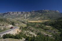 Cerdana Valley in the foothills of the Pyrenees with car parked on road in foreground.Automobile Automotive Cars Catalunya Espainia Espana Espanha Espanya European Hispanic Motorcar Scenic Southern E...