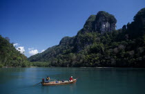 Pulau Dayang Bunting island with hunters arriving in a traditional long boatMalaysian Southeast Asia Asian Classic Classical Historical Older Scenic Southern