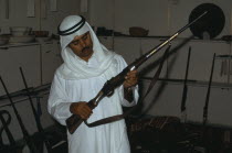Man holding an old rifle in Doha MuseumHistory Male Men Guy Middle East One individual Solo Lone Solitary Qatari
