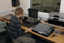 Students using sound desk in school recording studio.European Immature Kids Learning Lessons Teaching