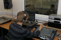 Students using sound desk in school recording studio.European Immature Kids Learning Lessons Teaching