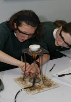 Food technology science class pupil using bunsen burner European Immature Kids Learning Lessons Teaching