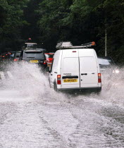 Cars driving through flash floods in Sevenoaks Kent.European  Flood Automobiles Autos Holidaymakers Tourism Tourist