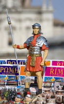 Souvenir stall in the Forum with statue of a uniformed Roman soldier among map guides in different languagesEuropean Italia Italian Roma Southern Europe History