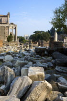 Fallen remains of buildings in the Forum with the Temple of Antoninus and Faustina on the left and the Arch of Titus in the distanceEuropean Italia Italian Roma Southern Europe Religion