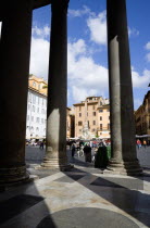 Piazza della Rotonda seen through the granite columns of the Pantheon with tourists walking in the squareEuropean Italia Italian Roma Southern Europe Gray History Holidaymakers Religion Religious Tou...