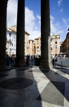 Piazza della Rotonda seen through the granite columns of the Pantheon with tourists walking in the squareEuropean Italia Italian Roma Southern Europe Gray History Holidaymakers Religion Religious Tou...