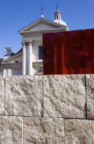 Neo Classical Church of San Rocco and red perspex cube behind a stone wall at the Ara PacisEuropean Italia Italian Roma Southern Europe History Learning Lessons Religion Religious Teaching