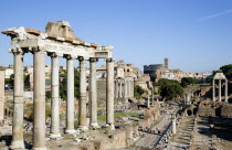 View of The Forum with the Colosseum rising behind the bell tower of the church of Santa Francesca Romana with tourists and the columns of the Temple of Saturn in the foregroundEuropean Italia Italia...