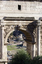 The floor of the Forum with tourists and the remains of the Temple of Vesta seen through the triumphal Arch of Septimius SeverusEuropean Italia Italian Roma Southern Europe History Holidaymakers Reli...