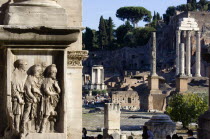 The floor of the Forum with tourists. A detail of the Arch of Septimius Severus the Temple of Vesta and the three Corinthian columns of the Temple of Castor and Pollux in front of the Palatine hillEu...