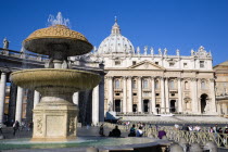Vatican City The Basilica of St Peter and the square or Piazza San Pietro with tourists around a water fountain in the foregroundEuropean Italia Italian Roma Southern Europe Catholic Principality Cit...