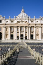 Vatican City The Basilica of St Peter with tourists at the entrance and empty seating for the Papal audience in the Piazza San PietroEuropean Italia Italian Roma Southern Europe Catholic Principality...