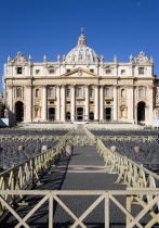 Vatican City The Basilica of St Peter with tourists at the entrance and empty seating for the Papal audience in the Piazza San PietroEuropean Italia Italian Roma Southern Europe Catholic Principality...