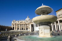 Vatican City The Basilica of St Peter and the square or Piazza San Pietro with tourists and a water fountain in the foregroundEuropean Italia Italian Roma Southern Europe Catholic Principality Citta...