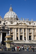 Vatican City The Basilica of St Peter with tourists at the entrance and in the Piazza San Pietro beside a water fountainEuropean Italia Italian Roma Southern Europe Catholic Principality Citta del Va...