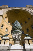 Vatican City Museums The Cortille della Pigna a huge bronze pine cone from a Roman fountain in a niche below the Papal heraldic crest in a niche by Pirro Ligorio on the Belvedere PalaceEuropean Itali...