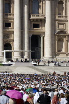 Vatican City Pope Benedict XVI under a canopy during an audience in Piazza San Pietro in front of the Basilica of Saint Peter with crowds in the squareEuropean Italia Italian Roma Southern Europe Cat...
