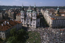 Elevated view over Old Town Square crowds and surrounding architecture.Ceska Eastern Europe European Praha Holidaymakers Tourism Tourist