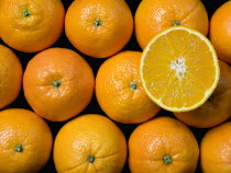 An overhead view down onto a group of oranges with one sliced open on top of the othersHealth Healthy Eating Nutrition Orange Citrus Citric Acid 1 Single unitary Health Healthy Eating Nutrition Oran...