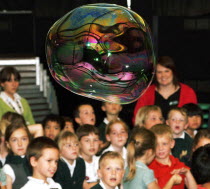 Primary school children facinated by the bubbles at the Bubble Show staged by the Science Museum as part of science day.European Immature Kids Learning Lessons Teaching Young Unripe Unripened Green