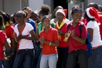 Girl Guides at Christmas singing carols in the street as part of their community service with one girl playing a tambourineCultural Cultures Immature Kids Order Fellowship Guild Club Religious West I...