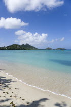 The calm clear blue water breaking on Paradise Beach in LEsterre Bay with Point Cistern and The Sister Rocks in the distanceCaribbean Grenadian Greneda West Indies Grenada Beaches Resort Sand Sandy S...