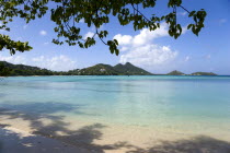 The calm clear blue water breaking on Paradise Beach in LEsterre Bay with Point Cistern and The Sister Rocks in the distanceCaribbean Grenadian Greneda West Indies Grenada Beaches Resort Sand Sandy S...