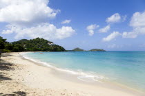 The calm clear blue water breaking on Paradise Beach in LEsterre Bay with Point Cistern and The Sister Rocks in the distanceCaribbean Grenadian Greneda West Indies Grenada Beaches Resort Sand Sandy S...