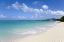 The calm clear blue water breaking on Paradise Beach in LEsterre Bay as two fishermen beach their boat with Sandy Island and Petite Martinique in the distanceCaribbean Grenadian Greneda West Indies G...