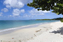 The calm clear blue water breaking on Paradise Beach in LEsterre Bay with Sandy Island and Petite Martinique in the distanceCaribbean Grenadian Greneda West Indies Grenada Beaches Martiniquean Resort...