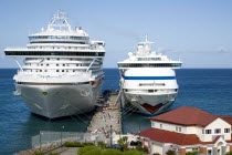 Two cruise ships the Caribbean Princess and Aida Aura moored at the cruise ship terminal in the capital city of St Georges with passengers walking along the jetty between the linersCaribbean Grenadia...