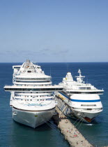 Two cruise ships the Caribbean Princess and Aida Aura moored at the cruise ship terminal in the capital city of St Georges with passengers walking along the jetty between the linersCaribbean Grenadia...