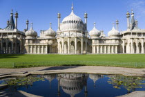 The onion shaped domes of the 19th Century Pavilion designed in the Indo- Saracenic style by John Nash commissioned by George Prince of Wales later to become King George IV. The oval water lilly pond...