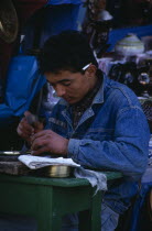Engraver at work in the medinaAl Qayrawan African Kairouan Middle East North Africa One individual Solo Lone Solitary