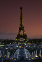 Eiffel Tower illuminated at dusk with illuminated fountains in the foregroundFrench Western Europe European