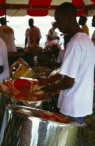WEST INDIES, Caribbean, Tobago, Music Katzenjammer Steel Band drummer playing drums or pans. 