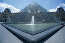 Louvre art gallery with a symetrical view of the Pyramid and fountain in the foregroundFrench Western Europe European