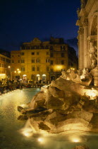 Trevi Fountain at night with people siting around the fountain Italia Italian Nite Roma Southern Europe European