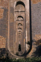 View through line of arches of railway viaduct in Sussex. European